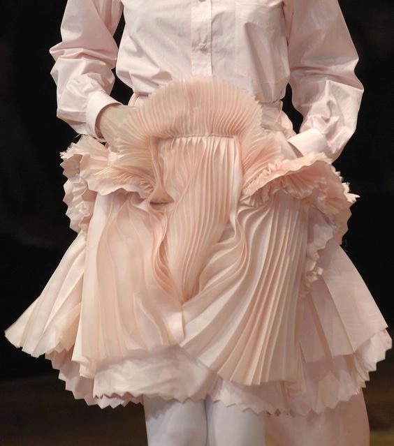 Pleated sculptural garment detail